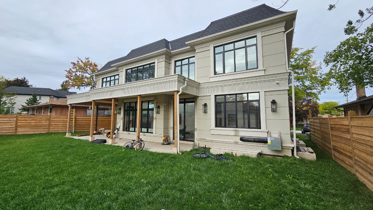 Premium black window frames and exterior stucco moldings prepped with professional paintable caulking on a luxury home in Burlington Ontario.