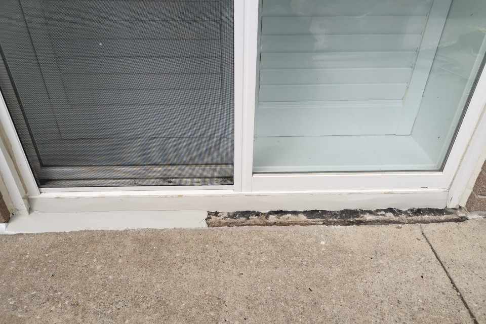 Residential exterior sealing process showing old caulking removed next to fresh professional bead.